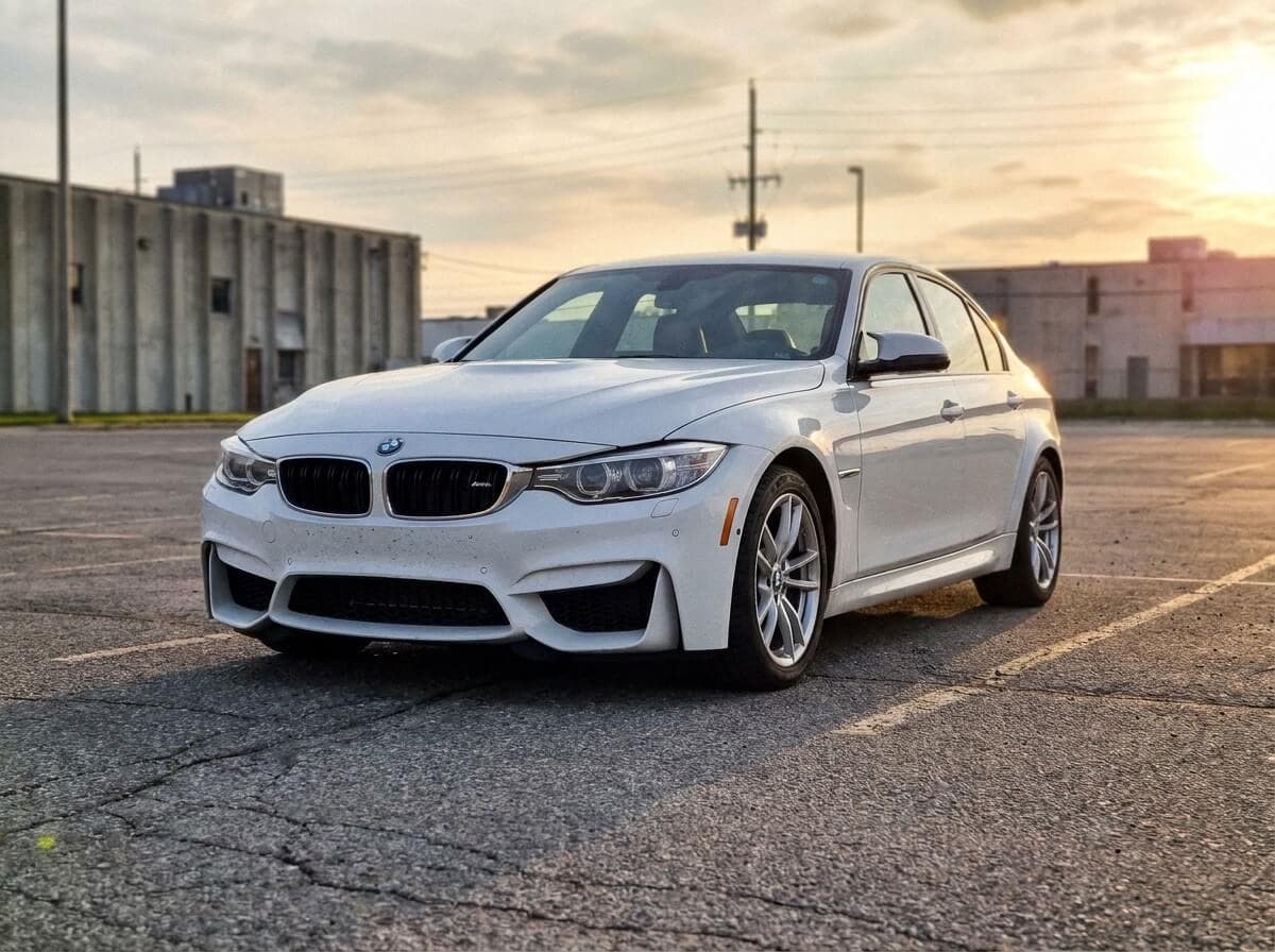 Customer's BMW M3 parked in an empty lot at golden hour, taken on a phone.